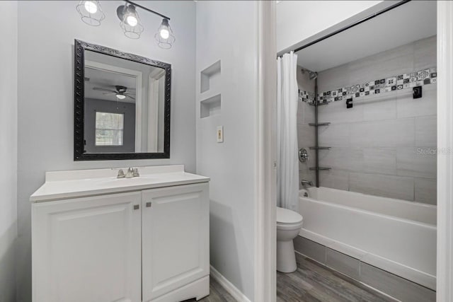 full bathroom with hardwood / wood-style floors, vanity, ceiling fan, toilet, and shower / bath combo with shower curtain