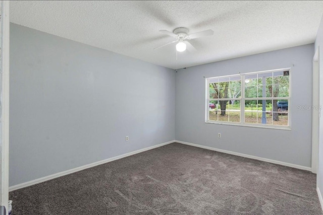 carpeted empty room with ceiling fan and a textured ceiling