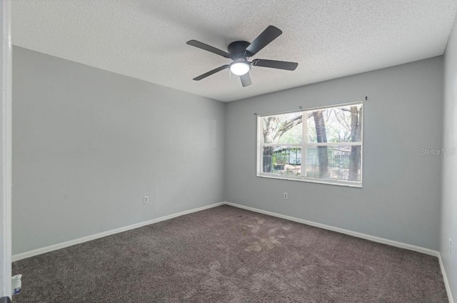 carpeted empty room with ceiling fan and a textured ceiling