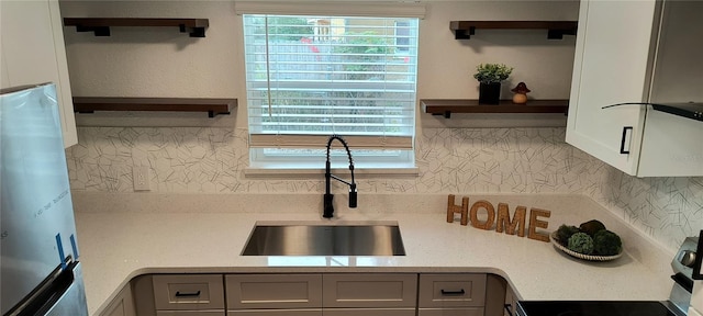 kitchen with sink, gray cabinetry, refrigerator, and stainless steel range