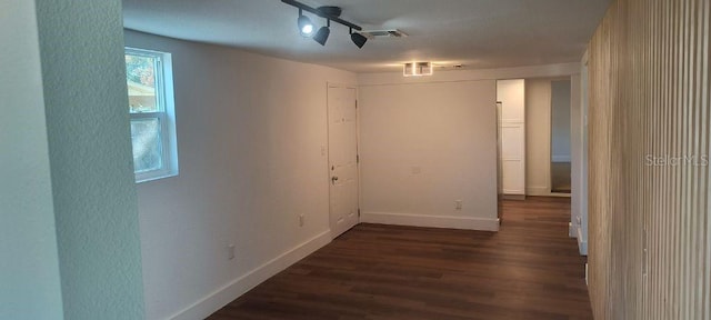 spare room with dark hardwood / wood-style flooring