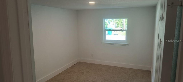 unfurnished room with carpet flooring