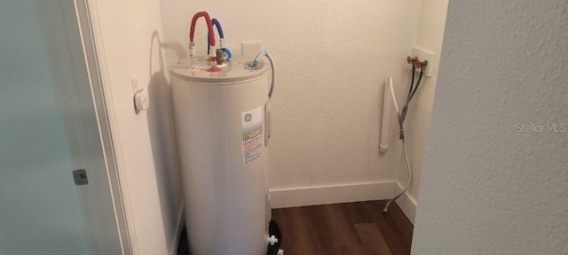 utility room featuring water heater