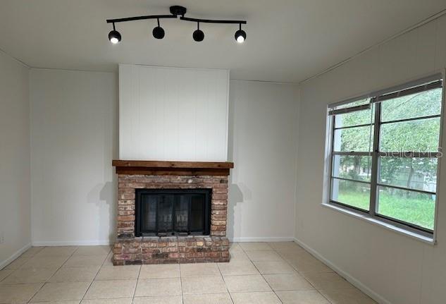 unfurnished living room featuring light tile patterned floors