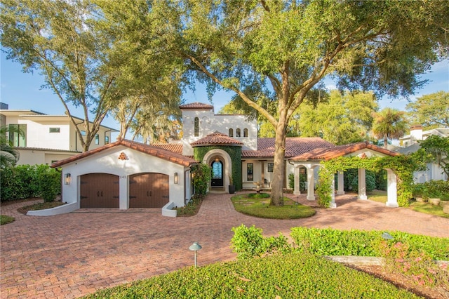 mediterranean / spanish-style home with a garage