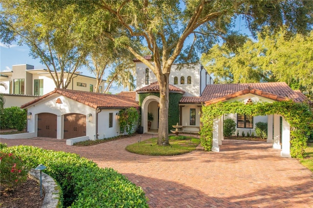 mediterranean / spanish-style home with a garage