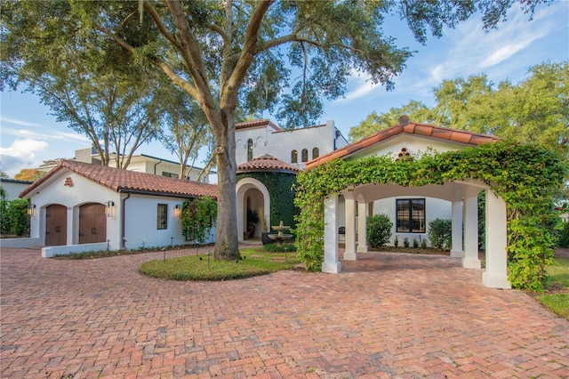 mediterranean / spanish-style house with a garage