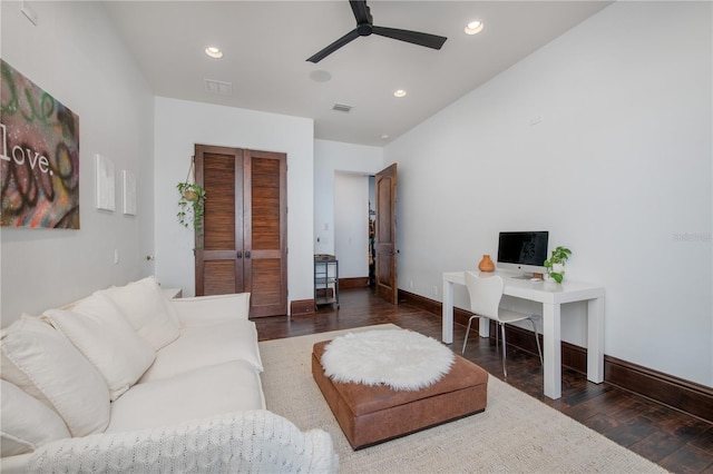 living room with ceiling fan and dark wood-type flooring