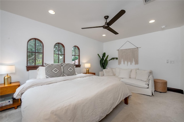 bedroom with ceiling fan and light colored carpet