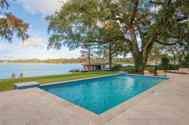 view of swimming pool with a water view, a yard, and a patio