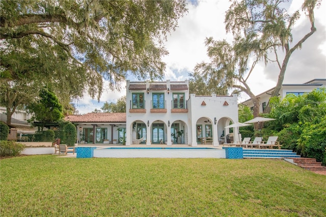 back of house featuring a patio area, ceiling fan, and a yard