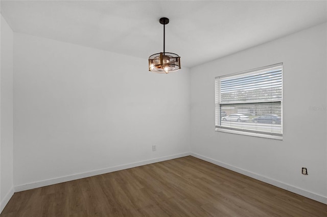 unfurnished room with dark hardwood / wood-style flooring