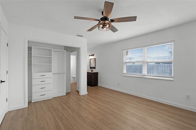 unfurnished bedroom featuring ceiling fan, a closet, and light hardwood / wood-style floors