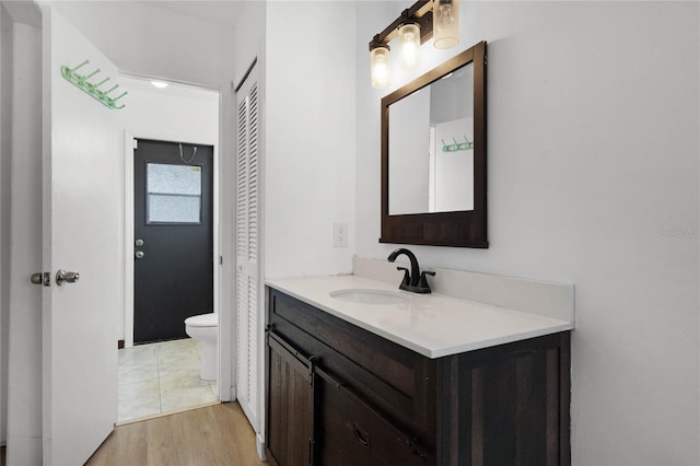 bathroom featuring vanity, toilet, and wood-type flooring