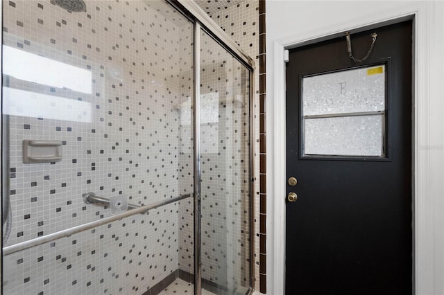 interior space with a shower with shower door