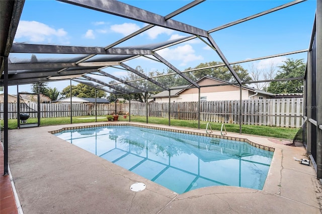 view of swimming pool featuring a patio area and a lanai