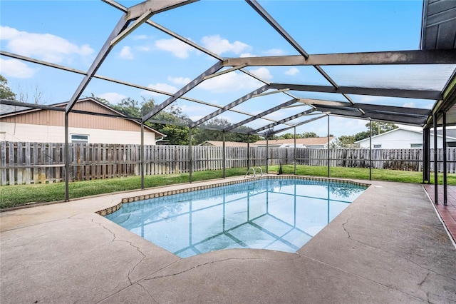 view of swimming pool with glass enclosure and a patio area