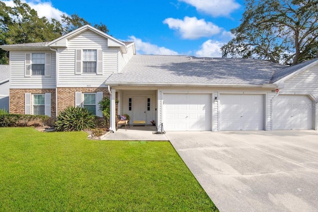 view of front of home featuring a garage and a front lawn