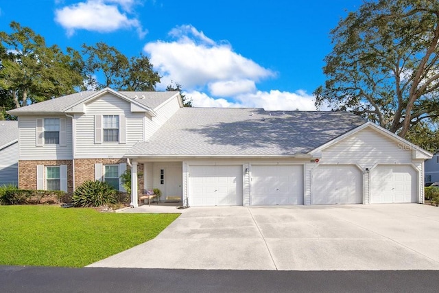 view of front of house with a garage and a front yard