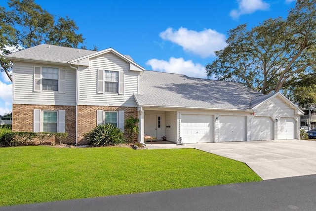 traditional-style house with a garage, brick siding, a shingled roof, concrete driveway, and a front yard