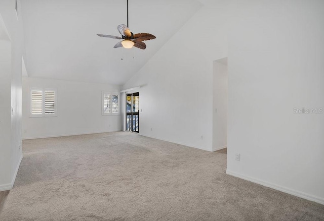 unfurnished living room with high vaulted ceiling, carpet, and a ceiling fan