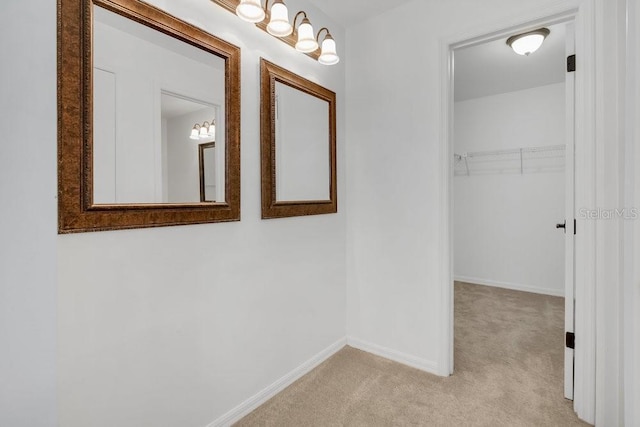 hall with light carpet and baseboards