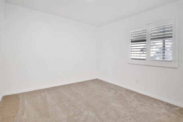 empty room with carpet floors and baseboards