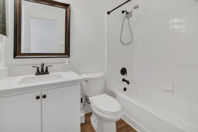 bathroom with tub / shower combination, vanity, toilet, and wood finished floors