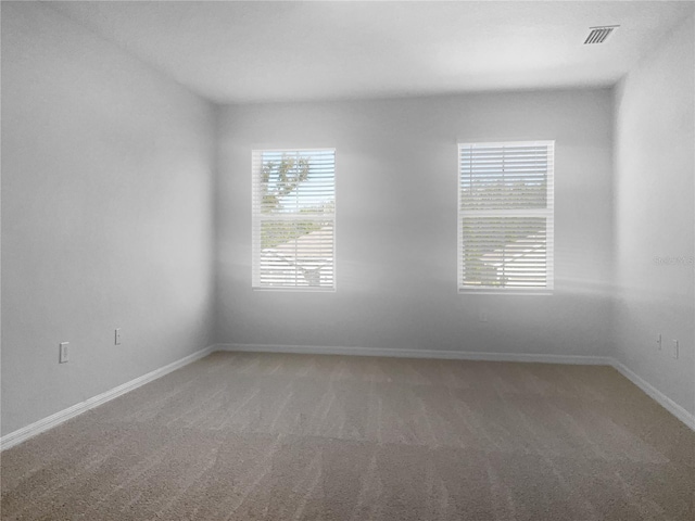 unfurnished room featuring carpet