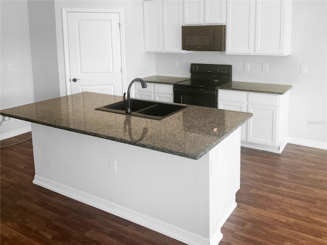 kitchen with black appliances, a center island with sink, white cabinetry, and sink