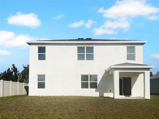 rear view of house with a lawn