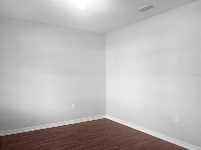 unfurnished room featuring dark hardwood / wood-style flooring