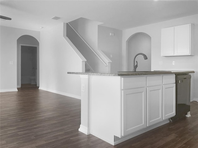 kitchen with white cabinetry, dark hardwood / wood-style flooring, stainless steel dishwasher, and sink