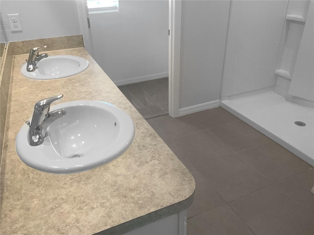 bathroom featuring tile patterned flooring, vanity, and walk in shower