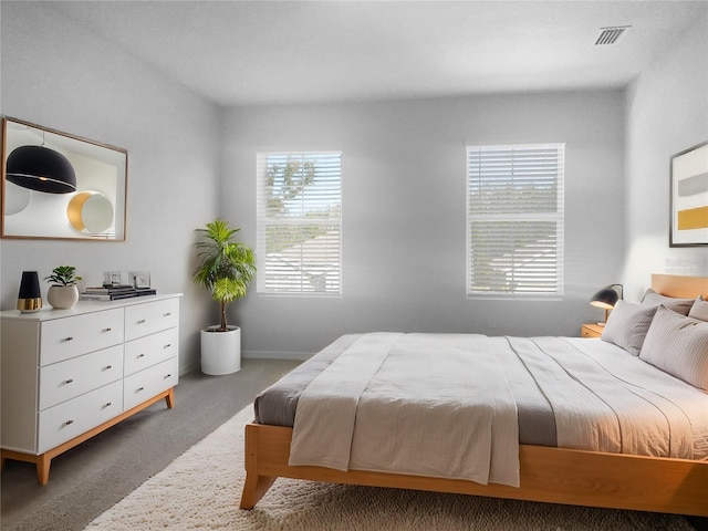 carpeted bedroom featuring multiple windows