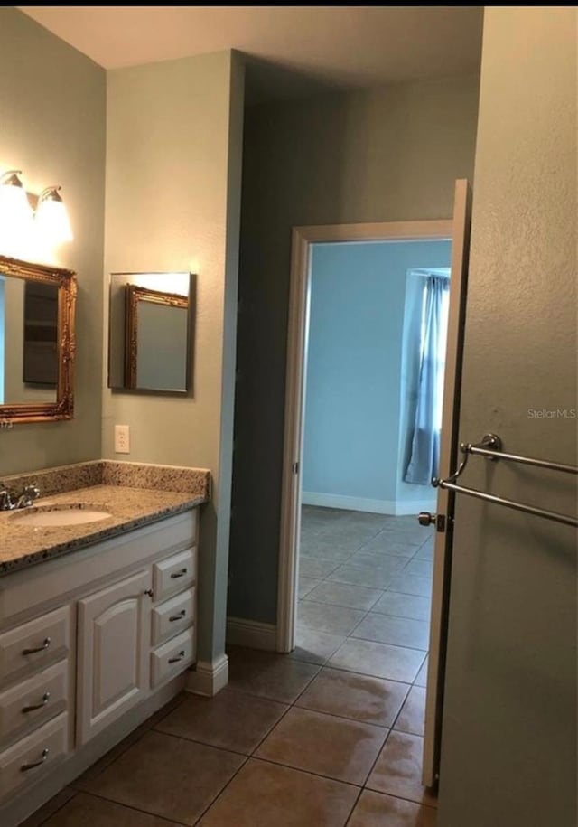 bathroom with tile patterned flooring and vanity