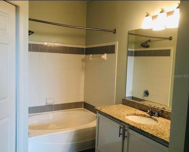 bathroom with vanity and tiled shower / bath combo