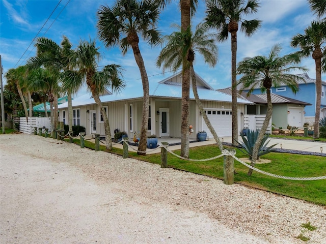 view of front of home featuring a garage and a front lawn