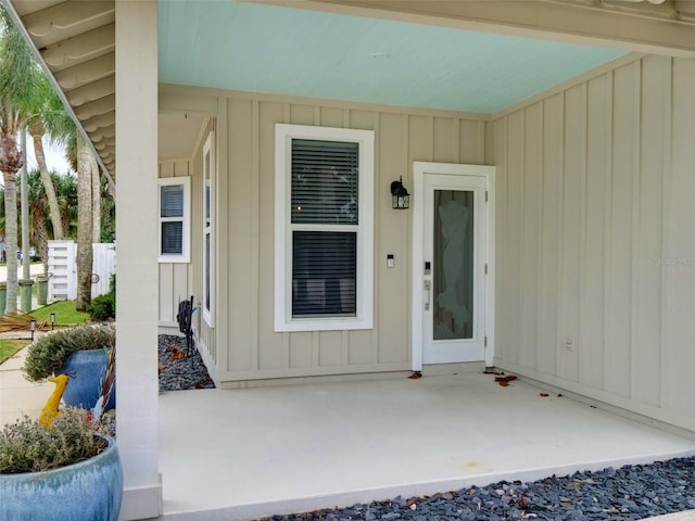 view of exterior entry with a patio