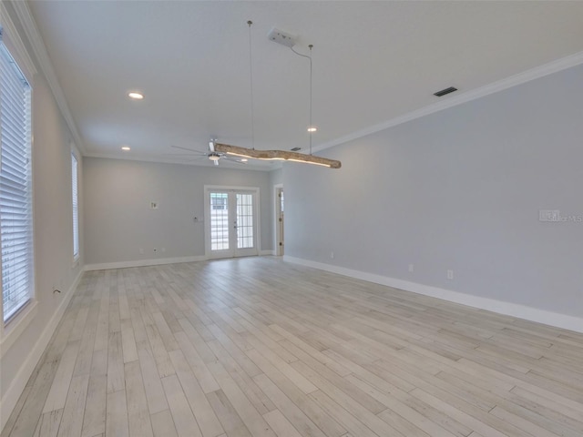 empty room featuring ceiling fan, french doors, light hardwood / wood-style flooring, and ornamental molding