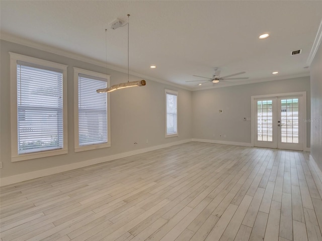 empty room with ceiling fan, light hardwood / wood-style floors, ornamental molding, and french doors