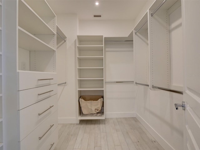 spacious closet featuring light hardwood / wood-style flooring