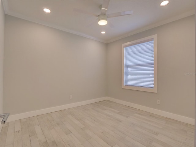 spare room featuring light hardwood / wood-style flooring and crown molding