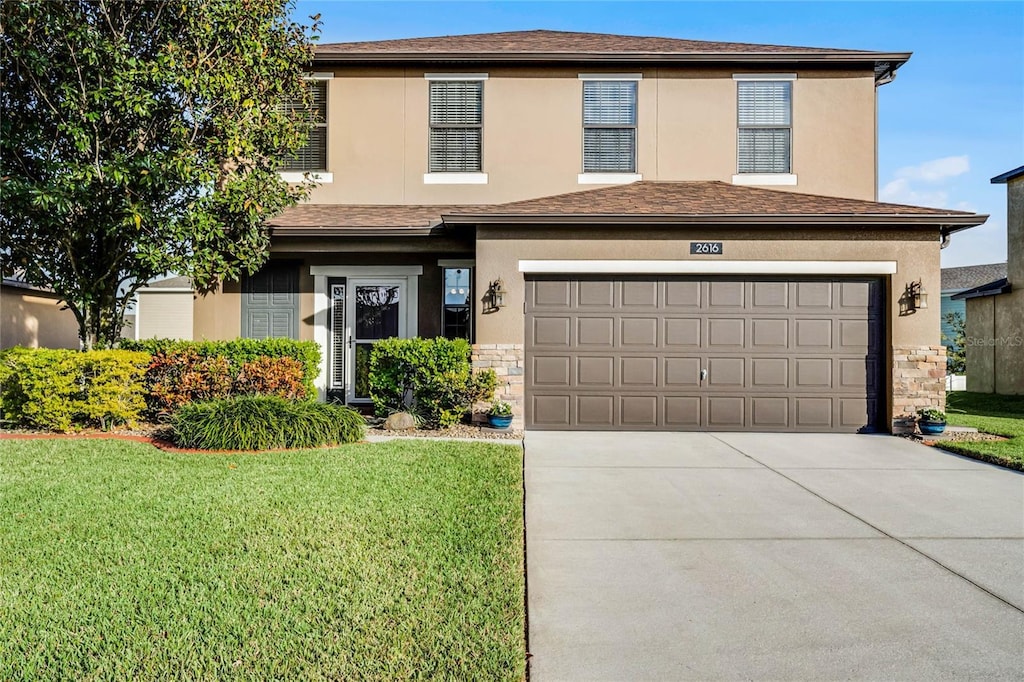 view of front property with a front lawn and a garage