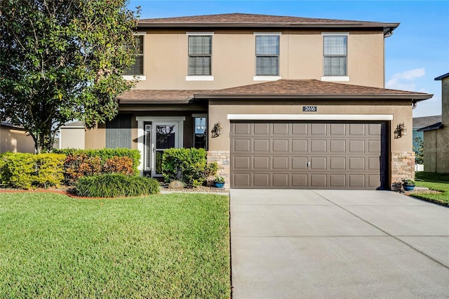 view of front property with a front lawn and a garage