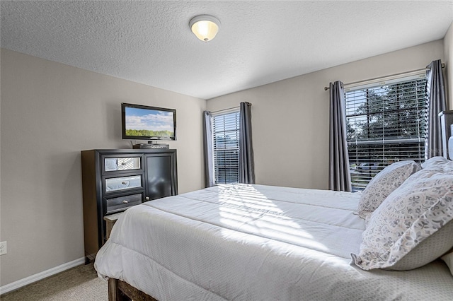 carpeted bedroom with a textured ceiling