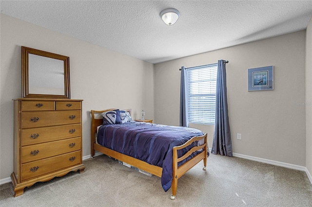 carpeted bedroom featuring a textured ceiling