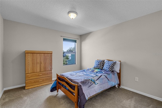 bedroom featuring a textured ceiling and carpet