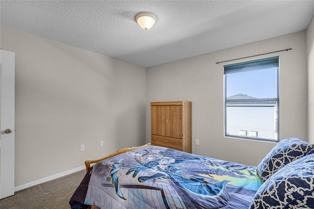 bedroom featuring a textured ceiling and carpet floors