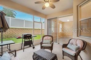 sunroom featuring ceiling fan